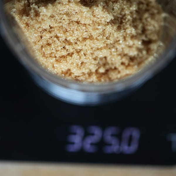 Bowl of brown sugar on a digital kitchen scale