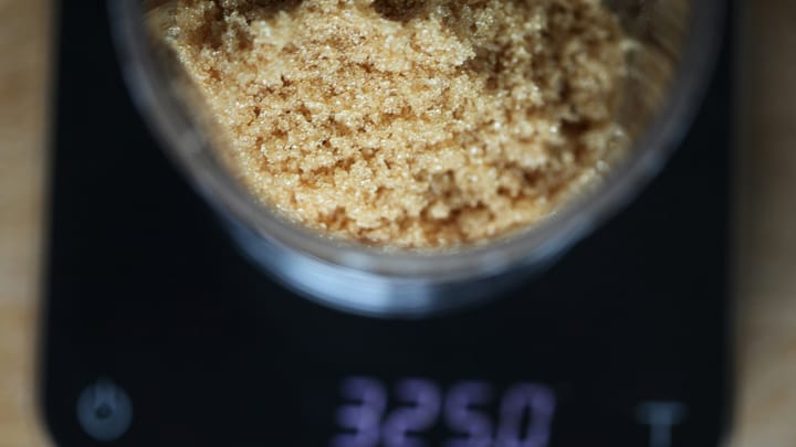 Bowl of brown sugar on a digital kitchen scale